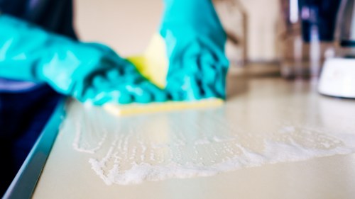 Technician performing deep carpet cleaning in a commercial space